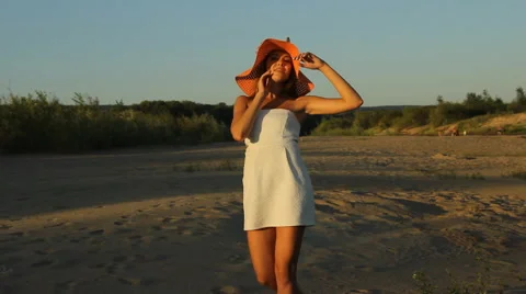 Girl posing on the shore in a hat Stock Footage 66724685