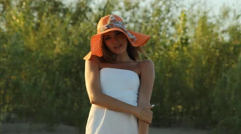 Girl posing on the shore in a hat Stock Footage 66724707