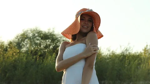 Girl posing on the shore in a hat Stock Footage 66724715