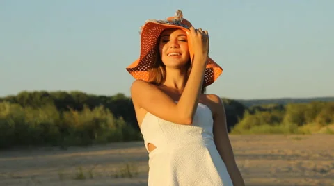 Girl posing on the shore in a hat Stock Footage 66724748