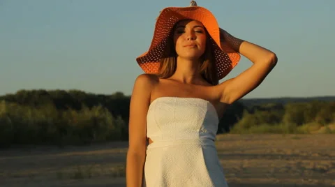 Girl posing on the shore in a hat Stock Footage 66724760