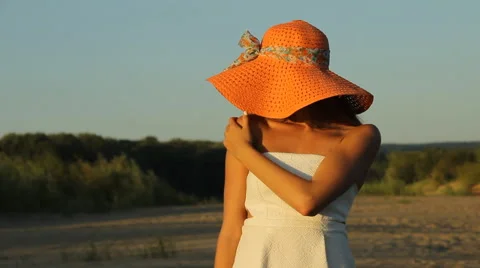 Girl posing on the shore in a hat Stock Footage 66724774