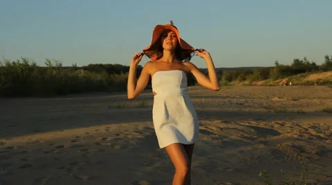Girl posing on the shore in a hat Stock Footage 66724791