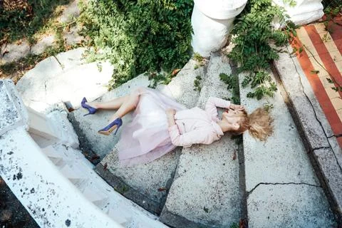 Girl is posing on the stone steps 스톡 사진