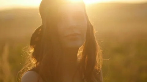 Girl posing at sunset in field Видео 63110515