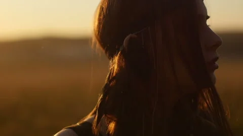 Girl posing at sunset in field Stock Footage 63110575