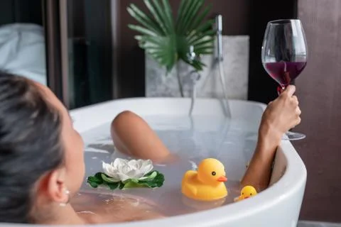 Girl posing while lying in a foam bath Stock Photos