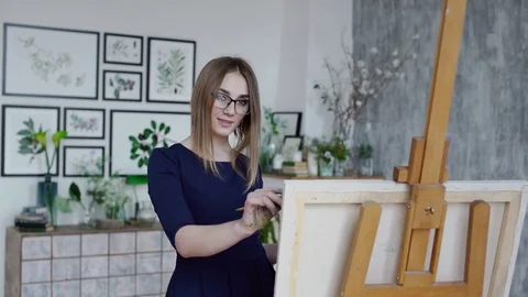 Girl posing while she paints Stock Footage 74641240