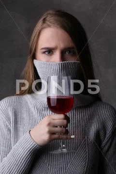 Girl Posing With Wineglass And Covered Face. Close Up. Gray Background