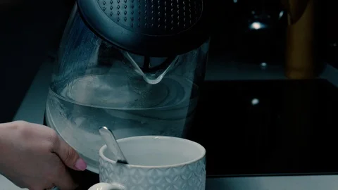 Girl pours water from their teapot Stock Footage