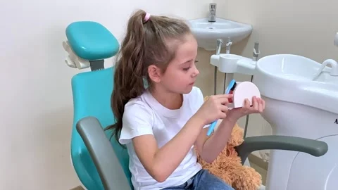 Girl is practicing how to properly brush her teeth. Good oral hygienist Stock Footage 268977372