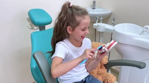 Girl is practicing how to properly brush her teeth. Good oral hygienist Stock Footage 268977380