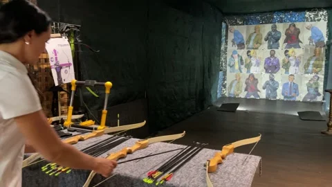 Girl practicing how to shoot with bow and arrows. Archer beginner. Video stock 168893482