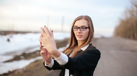 Girl preens doing selfie using front facing camera of the smartphone Stock-Footage 59757024