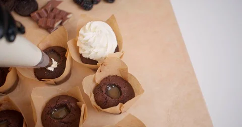 Girl prepares a cupcake at kitchen Stock Footage 128459876