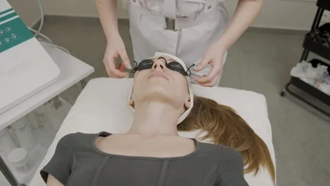 Girl prepares for permanent makeup application in a modern cosmetology studio Stock Footage 314257806