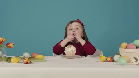 Girl preparing a cake for easter. has fun while mom is not looking. Happy Easter 스톡 동영상 130421645