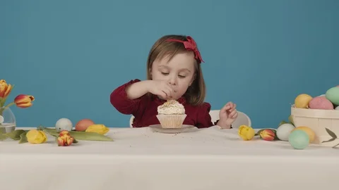 Girl preparing a cake for easter. sprinkled with colorful sweets. Happy Easter Video stock 129201331