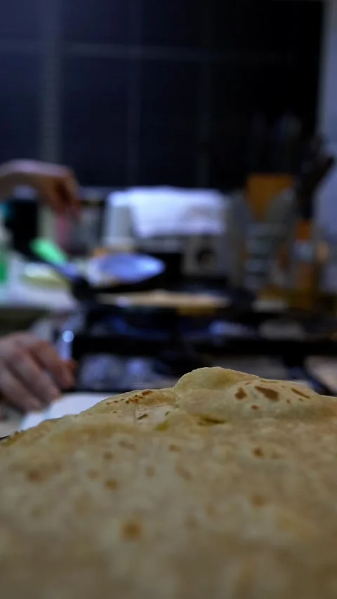Girl preparing chapati flatbread in kitchen, close-up focus Stock Footage 343876719