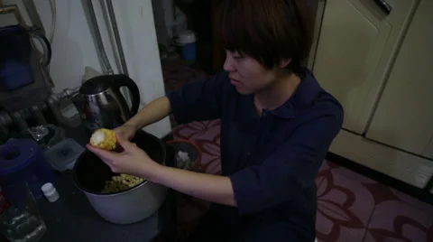 A girl preparing corn for cooking. Stock Footage 31739222