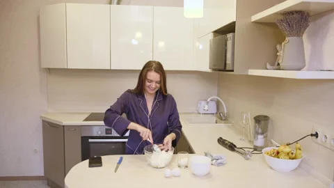 Girl  is preparing a healthy breakfast in the apartment kitchen Stock Footage 130239341