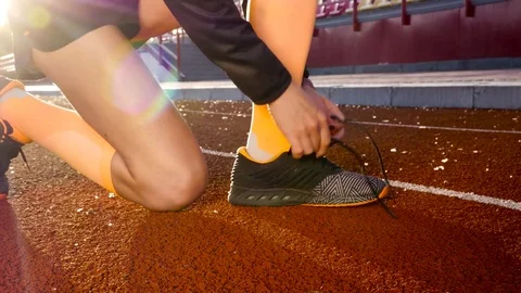 Girl preparing for running at stadium Stock Footage 77394044