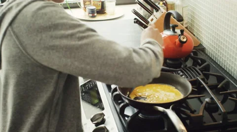 Girl preparing a scrambled egg in kitchen Stock Footage 63860711