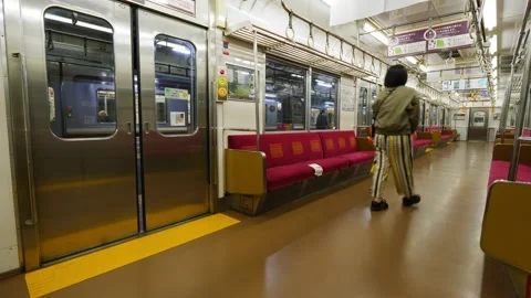 Girl presses the button and the train doors close with a warning signal Stock Footage 213814688