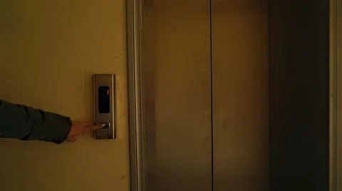 The girl presses the button to call the elevator Foto stock