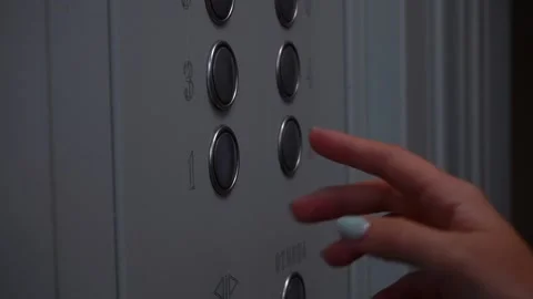 The girl presses the elevator button to the 1st floor Stock Footage 161250206