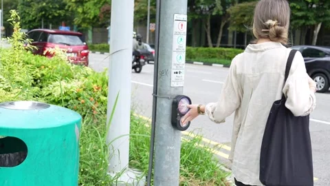 A girl is pressing the traffic light button Stock Footage 287305845