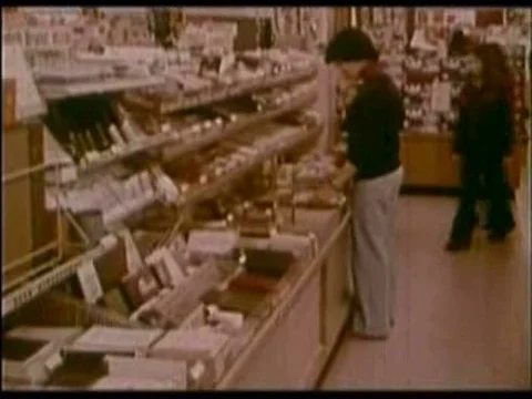 A girl pressures her friend into shoplifting in 1975. Stock Footage