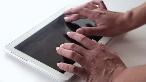 The girl prints the text on the tablet Video stock 73851879