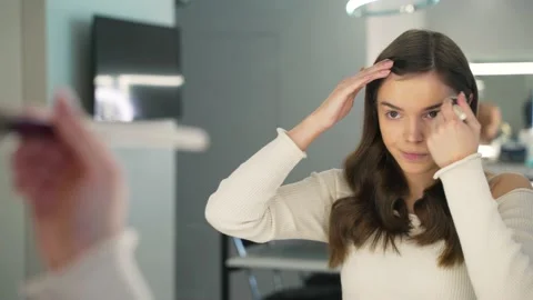 Girl with problem skin does makeup Stock Footage 146204198