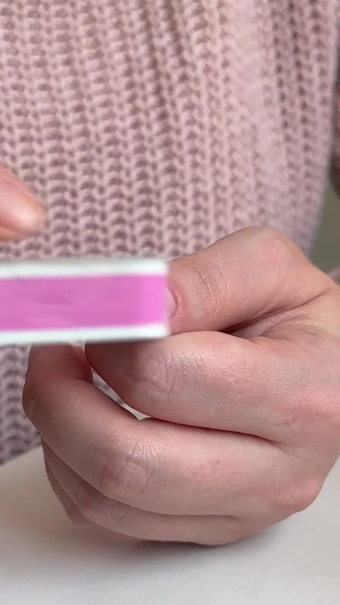 Girl processes her nails with a nail file, home manicure Stock Footage 255039668