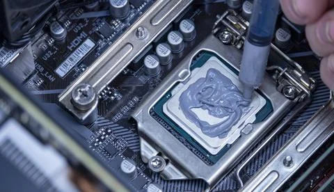 Girl programmer apply thermal paste on the computer processor, 写真素材