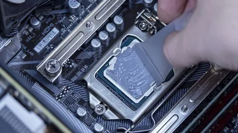 Girl programmer apply thermal paste on the computer processor, Stock Photos
