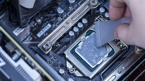 Girl programmer apply thermal paste on the computer processor, 写真素材