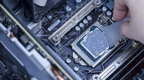 Girl programmer apply thermal paste on the computer processor, 写真素材