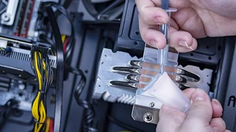 Girl programmer apply thermal paste on the computer processor, 写真素材