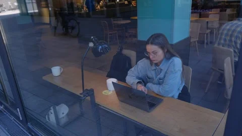 Girl programmer writes code in a cafe Stock Footage 278913919