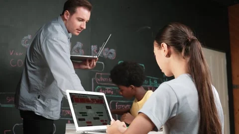 Girl programming or coding system while african boy fixing model. Edification Stock Footage 271079161