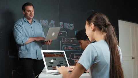 Girl programming or coding system while african boy fixing model. Edification Stock Footage 281286321