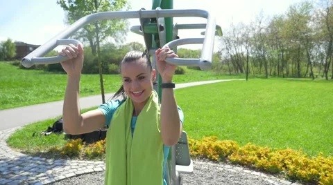 Girl is pulling up on the sport equipment in the park. Stock Footage 63393853