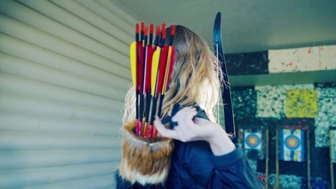 Girl pulls an arrow from the quiver Stock Footage 81927167