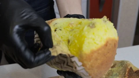 Girl pulls Easter cake from the wrapper. Stock Footage 128566945