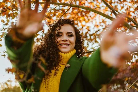 Girl pulls her hands into the camera smiling white-toothed charming smile Stock Photos