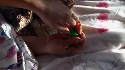 The girl pulls the thermometer out of the storage case Stock Footage 120698806