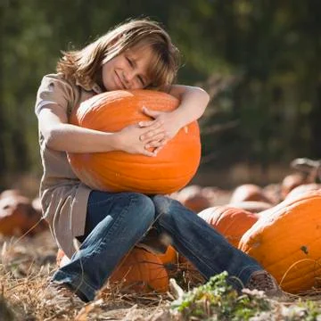 Girl in pumpkin patch Stock Photos