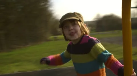 Girl pushes roundabout Stock Footage 22222441
